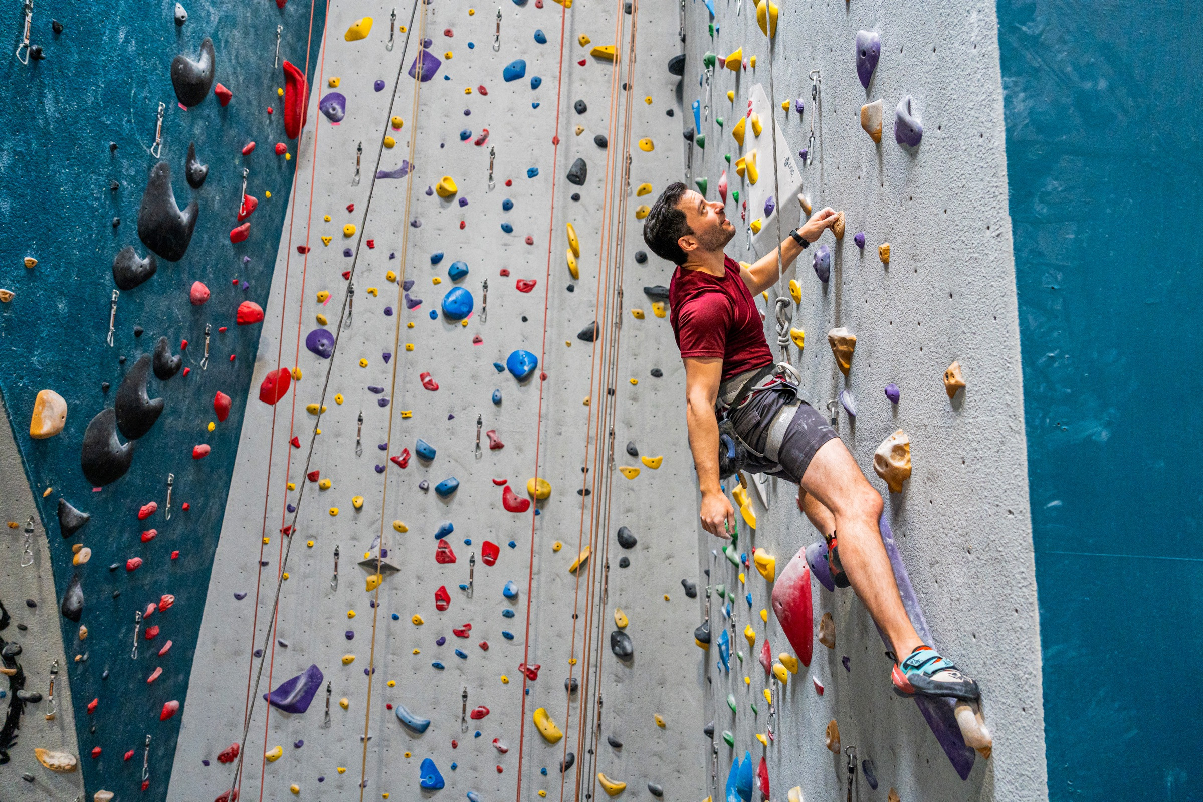 A man climbing in an indoor gym